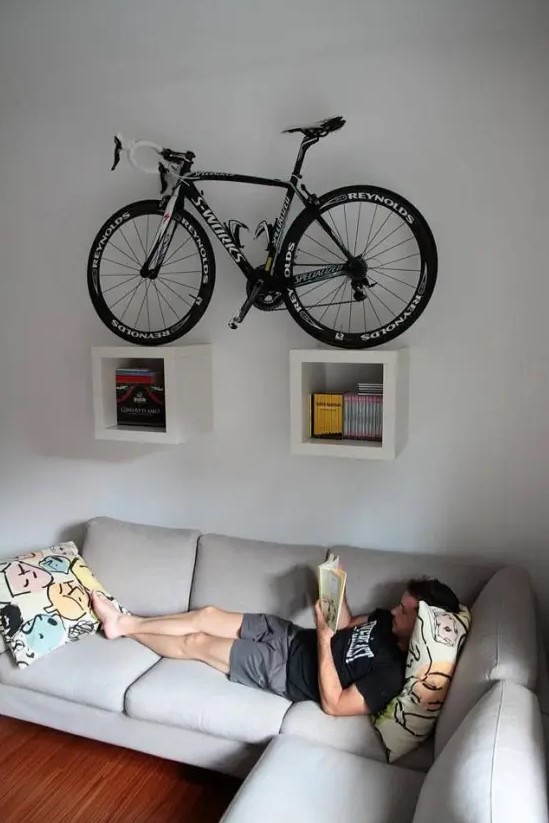 two box shelves attached to the wall and holding a bike can be a nice solution for a contemporary space and you may attached them anywhere, not only in an entryway