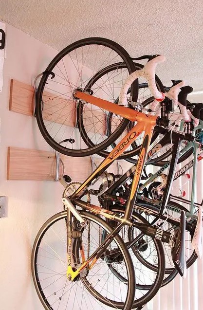 wooden shelves with hooks can securely store several bikes and can be a nice idea for any shed or other space