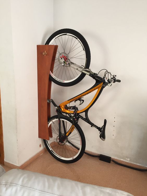 a creative and cool wall-mounted holder for a bike is a smart and stylish idea to store your bike comfortably and to show it off at the same time