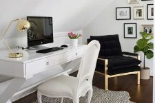 33 a chic and stylish attic work nook with a white desk and achair, a black chair, a stylish gallery wall, a Dolmatin print rug and touches of gold