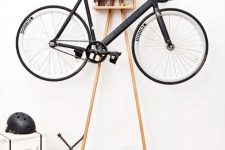 36 a small and ergonomic storage unit is a cool stand for a bike and can be placed anywhere, from an entryway to a porch, and it features some storage space, too