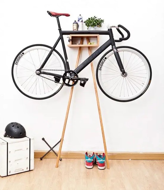 a small and ergonomic storage unit is a cool stand for a bike and can be placed anywhere, from an entryway to a porch, and it features some storage space, too