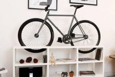 38 an open white storage cabinet is a cool way to display for all the stuff and for your bike, too, and it will be a nice idea for your home