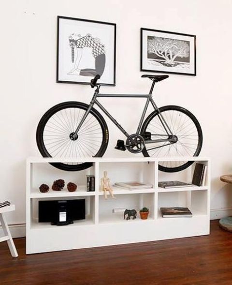 an open white storage cabinet is a cool way to display for all the stuff and for your bike, too, and it will be a nice idea for your home