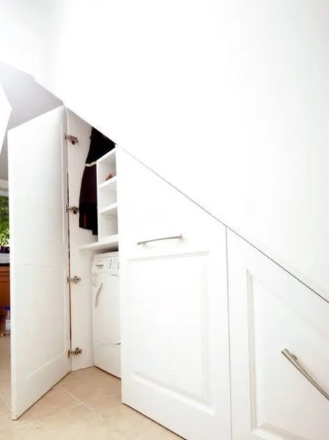 a built in laundry space under the stairs with much storage for the things is a lovely idea for a staircase   use this awkward nook to advantage