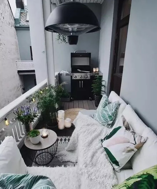 a cozy Nordic balcony with potted plants, printed textiles and a grill   all you need in one