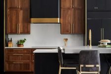 a dramatic two-tone kitchen with rich-stained cabinets, black ones, white stone countertops and a white backsplash, touches of gold here and there