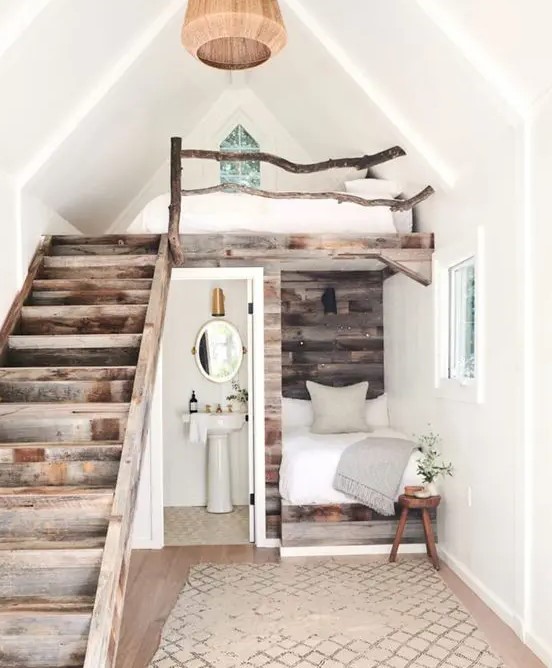 a little rustic apartment with a two bedrooms - a usual and a loft one, a bathroom and a pretty reclaimed wood staircase