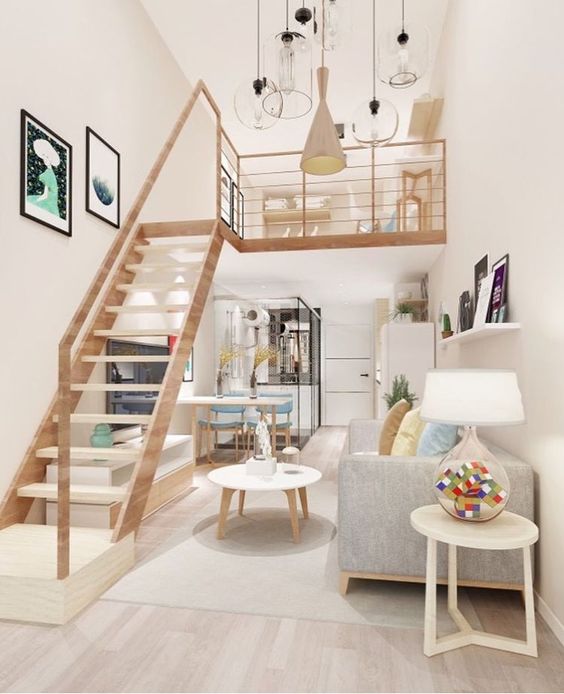 a lovely modern space with plenty of light, with a kitchen, dining and living room down, a ladder and a loft sleeping space, a cluster of pendant lamps