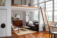 a mid-century modern home with a living and eating space below and a loft sleeping space with a wooden ladder is super cool