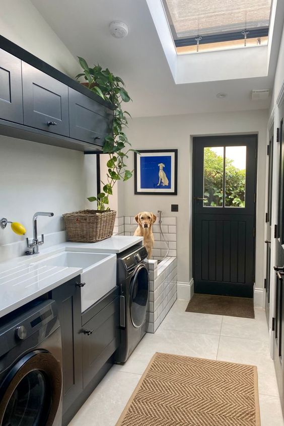 a modern farmhouse laundry with a skylight, black shaker style cabinets and a dog shower is a practical idea