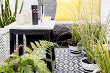a monochromatic balcony with printed textiles, potted greenery and succulents and simple and stylish furniture