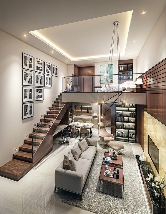a refined modern space with a dining and living room down, with a built-in working space and a kitchen, and a loft bedroom with a built-in bookcase