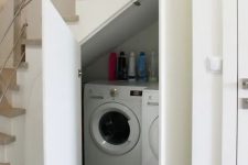 a small laundry with a washing machine and a dryer and with doors to hide them is a cool and smart idea to rock