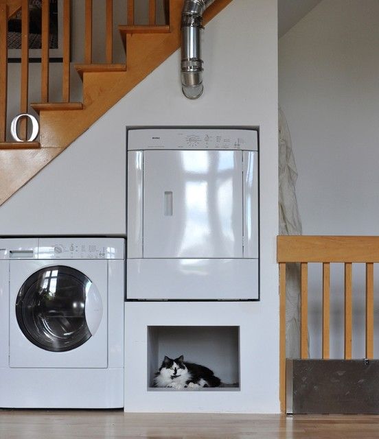 a staircase with a built-in washing machine and a dryer and a built-in cat space is a lovely idea for a modern space