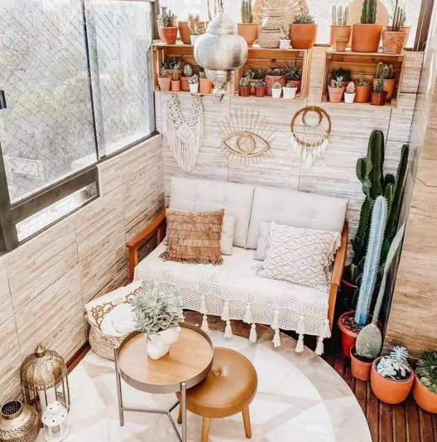 a stylish boho balcony with open shelves with lots of plants and potted succulents and cacti, a sofa with boho pillows, side tables and poufs is cool