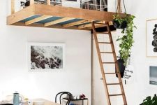 an eclectic apartment with a Scandinavian feel and a loft reading and working space with bookshelves is very cool