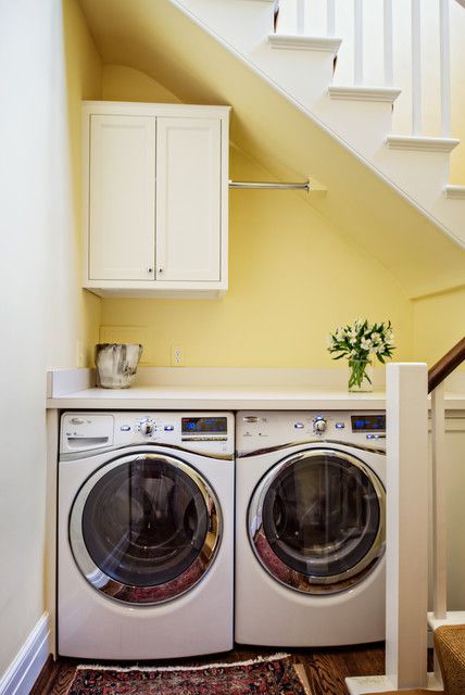 an under the stairs laundry with a storage cabinet, a washing machine and a dryer, a shelf for storage is a smart solution