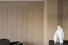 02 a plywood accent wall done with a series of frames adds elegance and a refined touch to the space