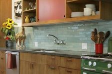 03 a bright mid-century modern kitchen with red and green touches and mint green skinny tiles on the backsplash