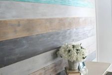 07 a wall covered with shabby and washed out wood in planks of different colors – beige, white, grey and graphite grey