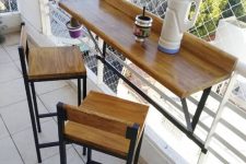 08 a small tabletop attached to the railing and a couple of tall matching stools are ready bar in the space