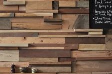 08 a unique accent wall done with lots of wooden slabs and planks in various colors adds a rustic and industrial touch