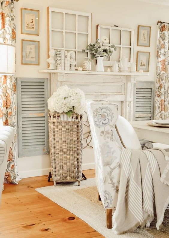 delicate neutral rustic decor around a faux fireplace with a vintage mantel, window frames, artwork and light grey shutters