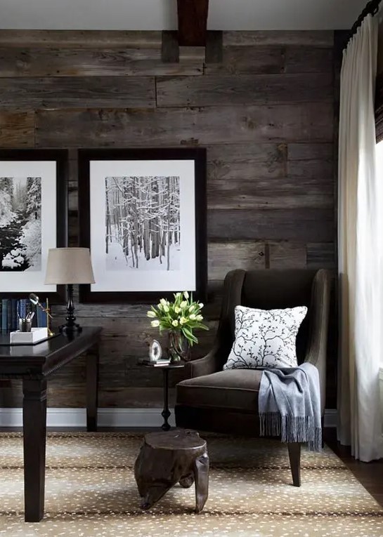 a dark weathered andaged board wall finishes off the moody space and makes it less formal and refined