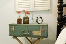 11 a nightstand of a green suitcase and trestle legs, with vases and a clock is a pretty vintage touch to your bedroom
