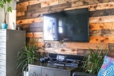 12 a weathered and stained wood accent wall softens the industrial-inspired living room with vintage touches