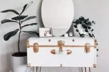 13 a pretty console table of a beautiful white vintage suitcase with gold detailing, on hairpin legs, with a mirror and some plants