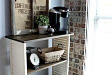 16 a cozy rustic drink station – a piece on casters made of shutters, a stained countertop, a rustic artwork, some mugs and a coffee machine