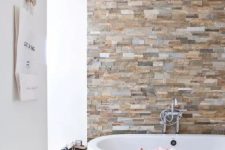 18 an earthy colored faux stone accent wall is a gorgeoys way to spruce up a neutral contemporary bathroom