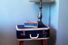 19 a vintage suitcase on stained legs as a coffee table with books and a table lamp is a bold and cool idea for a vintage-infused space