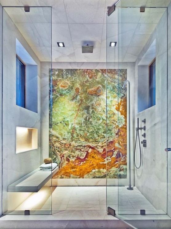 a spa like shower space accented with a colorful geode statement wall that makes the shower even more gorgeous
