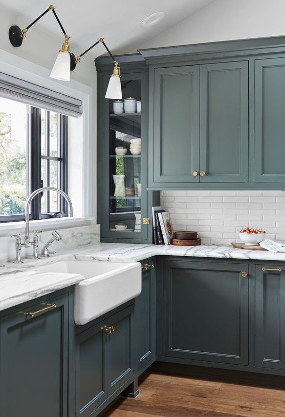an elegant vintage green kitchen with skinny white tiles and marble countertops for a more refined and stylish look