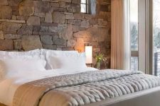 24 a natural stone accent wall behind the headboard makes this bedroom cozier and more inviting