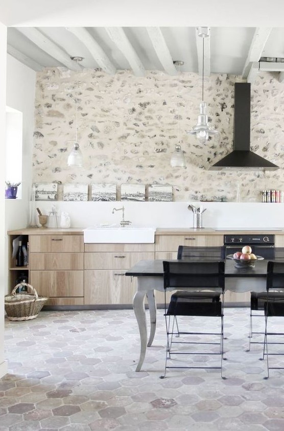 a contemporary kitchen made catchy with a whitewashed stone accent wall and neutral hex tiles on the floor