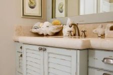 31 a sink vanity made of old pastel-colored shutters and a stone countertop for a beach-inspired bathroom