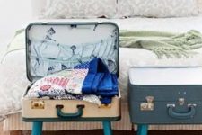 31 vintage suitcases placed on legs are great storage units for your bedroom, they can hold a lot of stuff and look cool