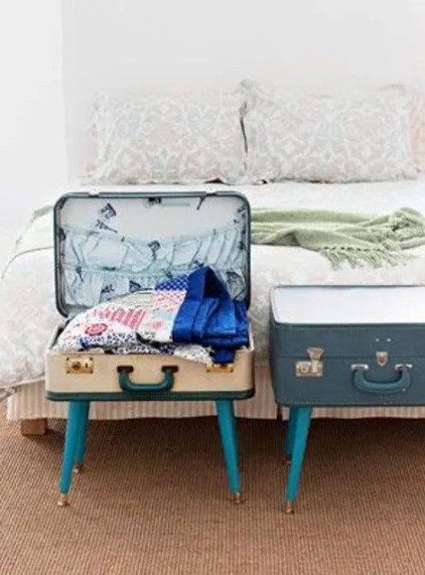 vintage suitcases placed on legs are great storage units for your bedroom, they can hold a lot of stuff and look cool