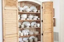 38 a built-in cupboard with shutters as doors is a sweet and cute idea for a farmhouse kitchen