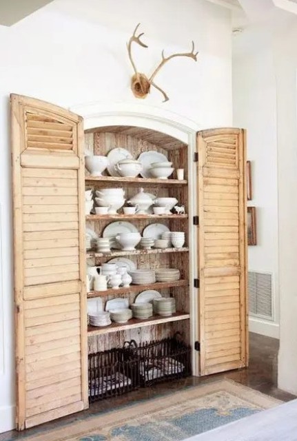a built in cupboard with shutters as doors is a sweet and cute idea for a farmhouse kitchen