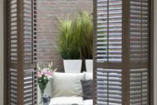 43 wooden shutter folding doors for terrace access is a chic idea to add farmhouse charm to the space
