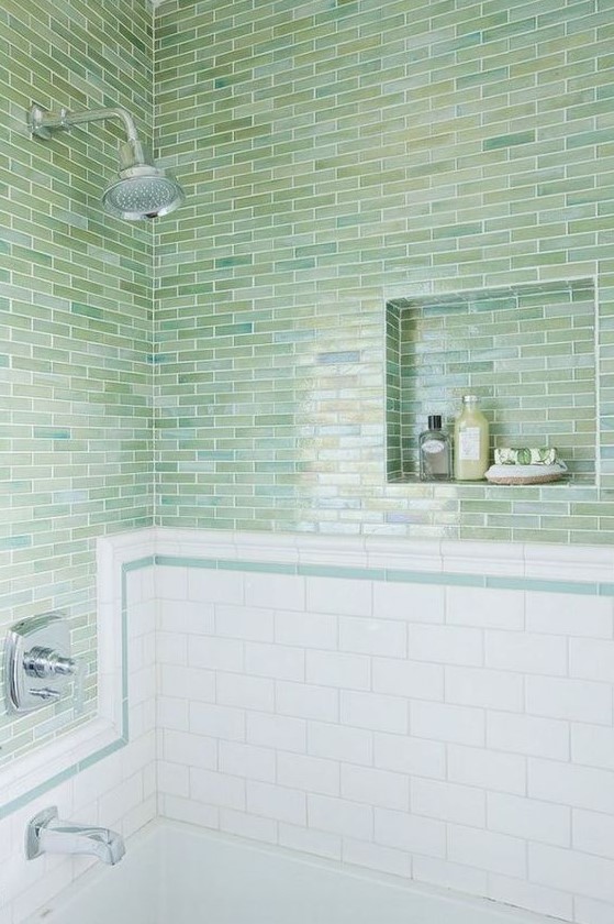 green blue skinny tiles clad horizontally paired with white subway tiles make up a stylish look