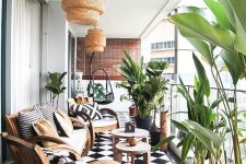 49 a stylish black and white balcony with a checked tile floor, wooden chairs and a sofa with black and white upholstery, potted greenery and woven pendant lamps