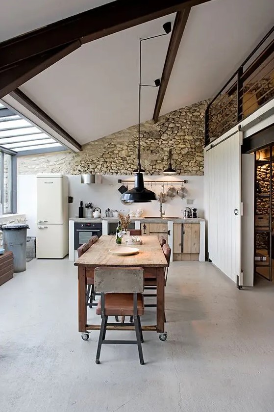 a cozy kitchen with a natural stone wall