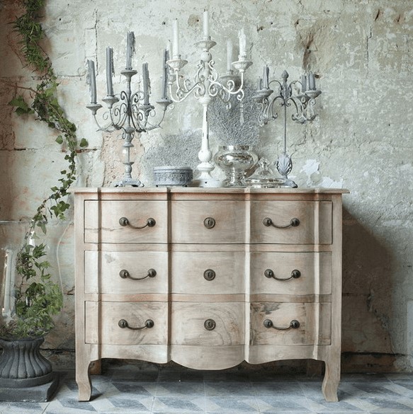 a beautiful light-stained wood vintage dresser with antique candlabras and accessories is a lovely piece for many living rooms and bedrooms