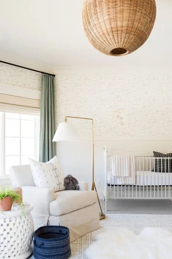 a neutral nursery with lovely wallpaper